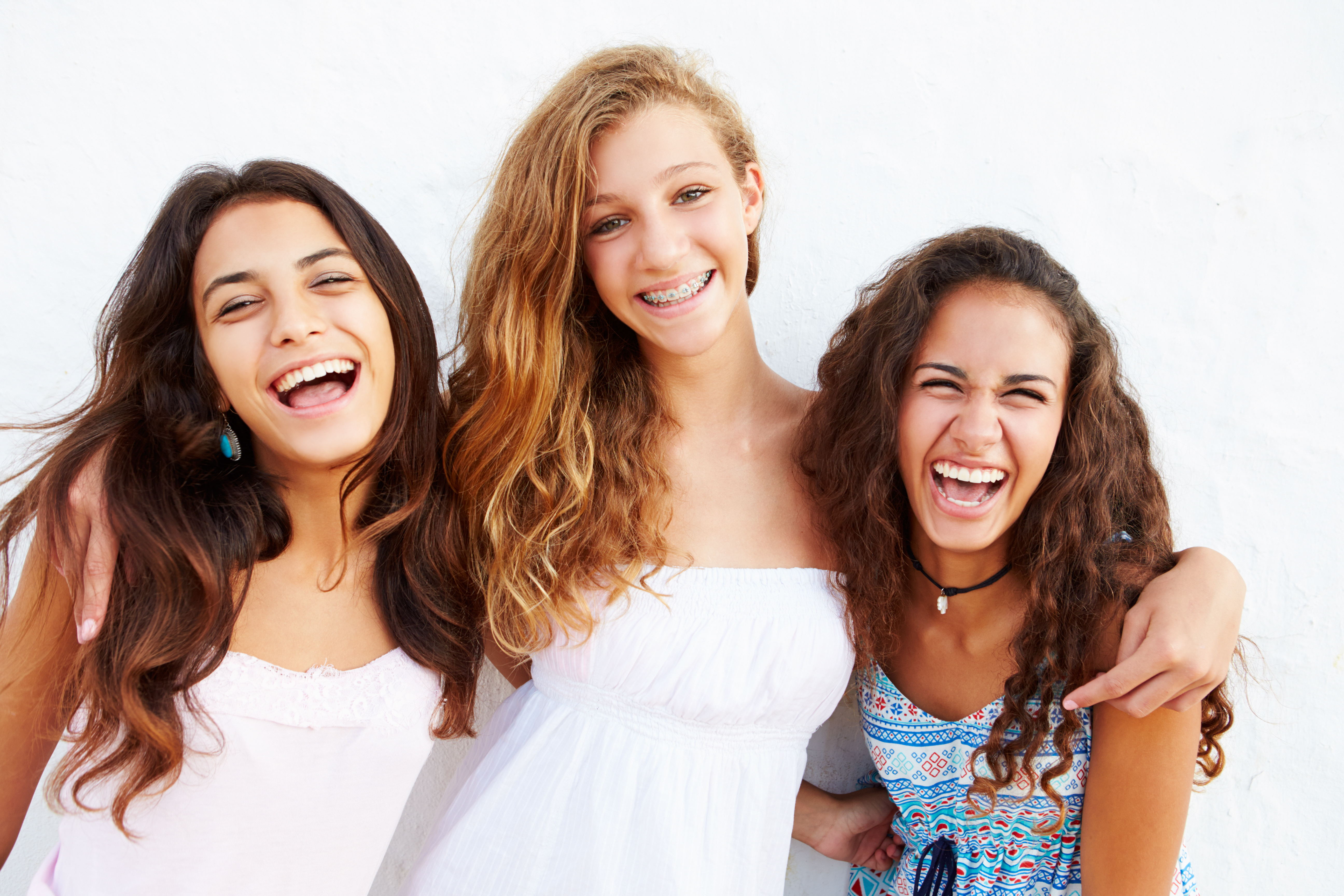 Portrait Of Three Teenage Girls Leaning Against Wall Dudley Smiles